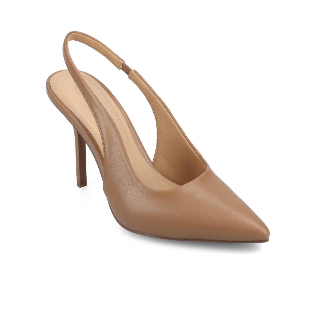 Close-up of tan suede pointed-toe slingback heels paired with cropped blue jeans, with legs playfully lifted in the air.