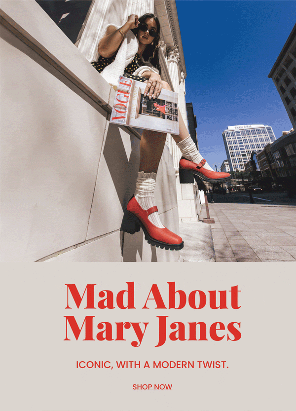 "Mad about Mary Janes" header text in red with "Iconic, with a modern twist." sub text. A model in a polka dot dress holding a fashion magazine with her red  Mary Jane shoes in focus. "Shop Now" call to action.