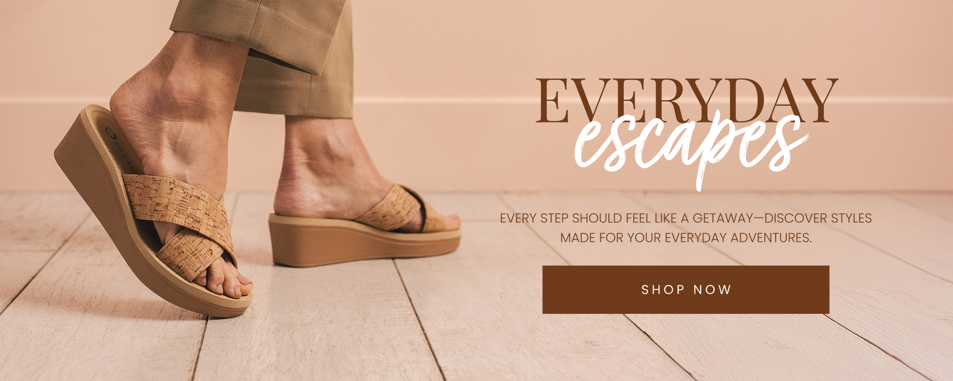 "Close-up of a person wearing cork-textured wedge sandals with crisscross straps, walking on a light wood floor. The text overlay reads 'Everyday Escapes' with a call-to-action button that says 'Shop Now.'"