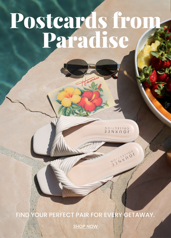 "Postcards from Paradise" header text with "find you perfect pair" subtext. Journee collection slide sandals in cream sit by a pool side next to a bowl of fruit, sunglasses, and post card. "Shop Now" CTA and button.